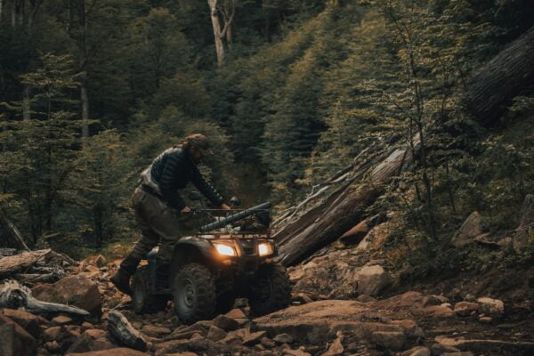 man in black jacket and black pants sitting on black jeep wrangler